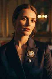 Western female model wearing baroque goddess cameo brooch on dark navy silk blazer lapel
