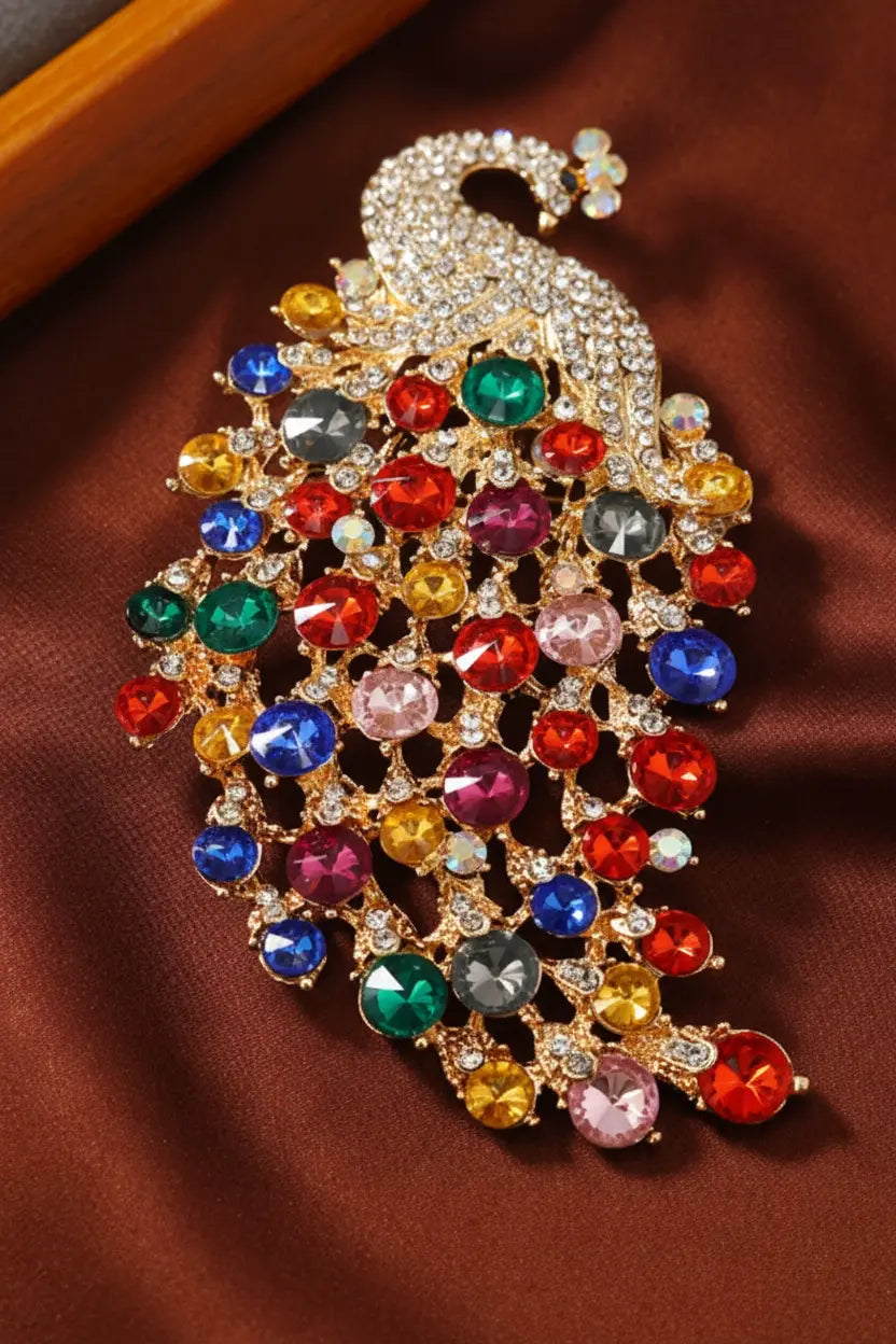 Macro close-up of multicolor crystal peacock brooch showing gemstone and filigree detail