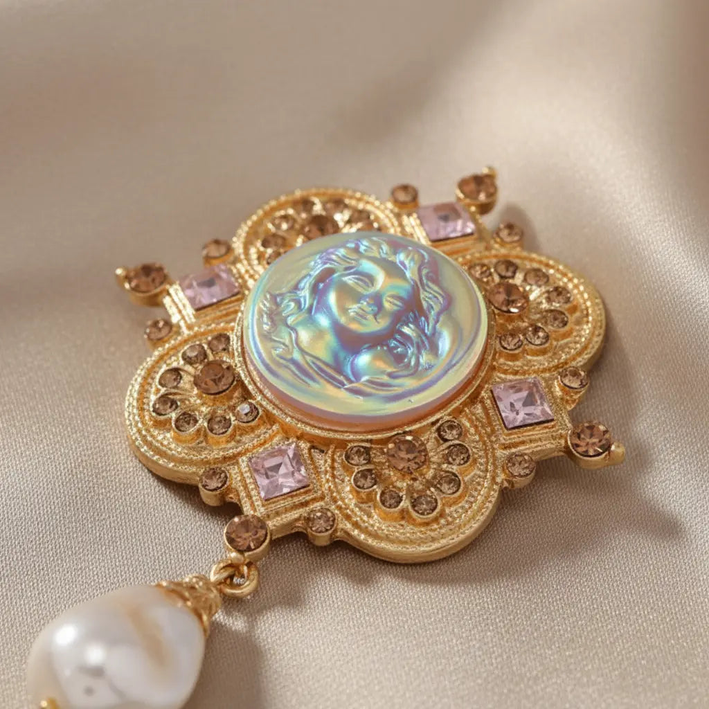 Macro close-up of baroque goddess cameo brooch showing iridescent medallion and gold filigree detail